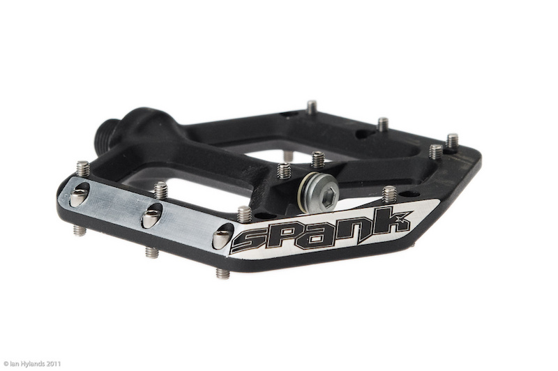 The Spike pedals use a slim 12mm thick body and chamfered leading and side edges to give more clearance and lessen the chance of damage from pedal strikes.</span></p><p><span>Spank Spike pedal details:</span></p><p>- Thin 12mm pedal body<br>- Large 90 sqcm platform<br>- 20 pins per pedal<br>- Cold forged and CNC optimized body<br>- Chamfered leading and side edges for improved impact deflection and more clearance<br>- Full compliment sealed inboard bearing<br>- Reduced diameter Igus outboard bushing<br>- Scandium enriched steel pedal axle<br>- Proprietary 